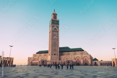 tourists walking and taking pictures at Hassan II mosque's square