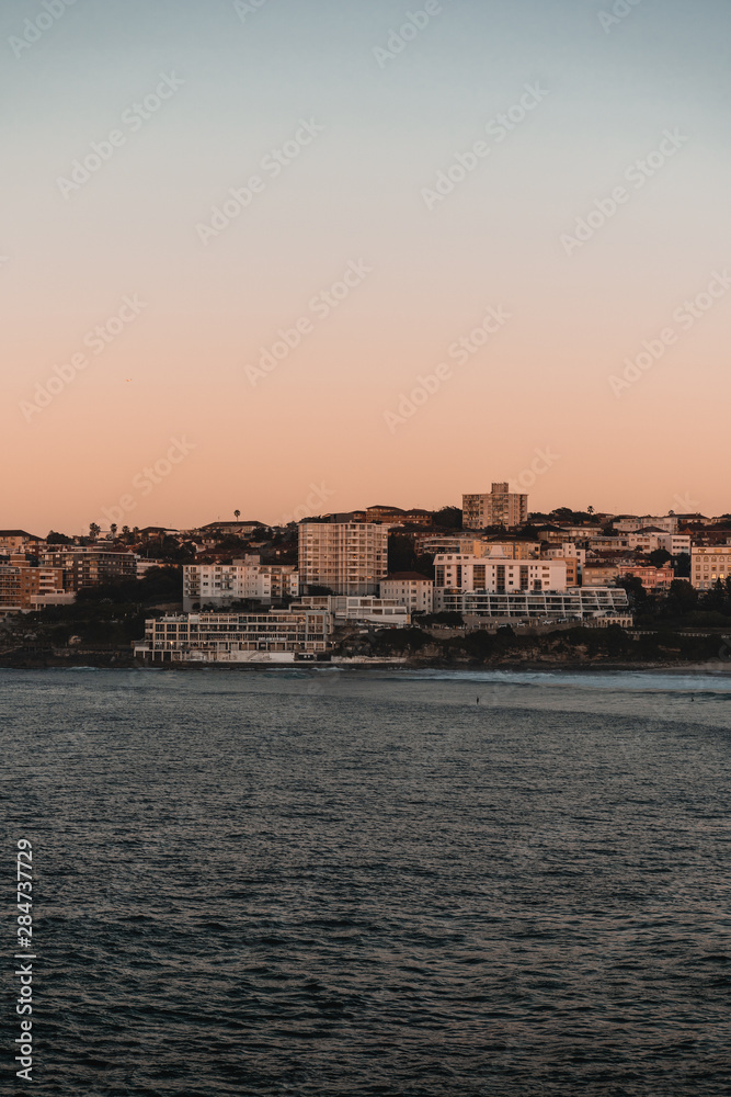 The first rays of morning sun hit the South Bondi Headland on a cold winter morning.