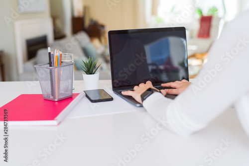 Younh woman using computer laptop with a blank screen