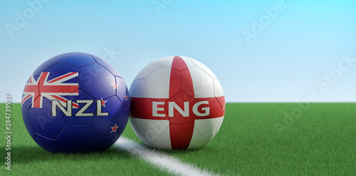 England vs. New Zealand Soccer Match - Soccer balls in England and New Zealand national colors on a soccer field. Copy space on the right side - 3D Rendering 