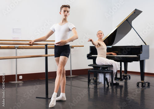 Female choreographer teaches young dancer in ballet studio