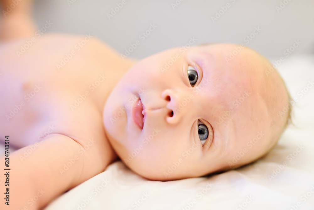Cute baby boy lying in bed closeup Cute baby boy lying in bed closeup