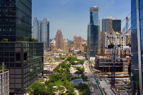 New York, USA - July 9, 2019: View of New York from a famous Vessel, designed by architect Thomas Heatherwick, at the Hudson Yards district in Manhattan on summer day.