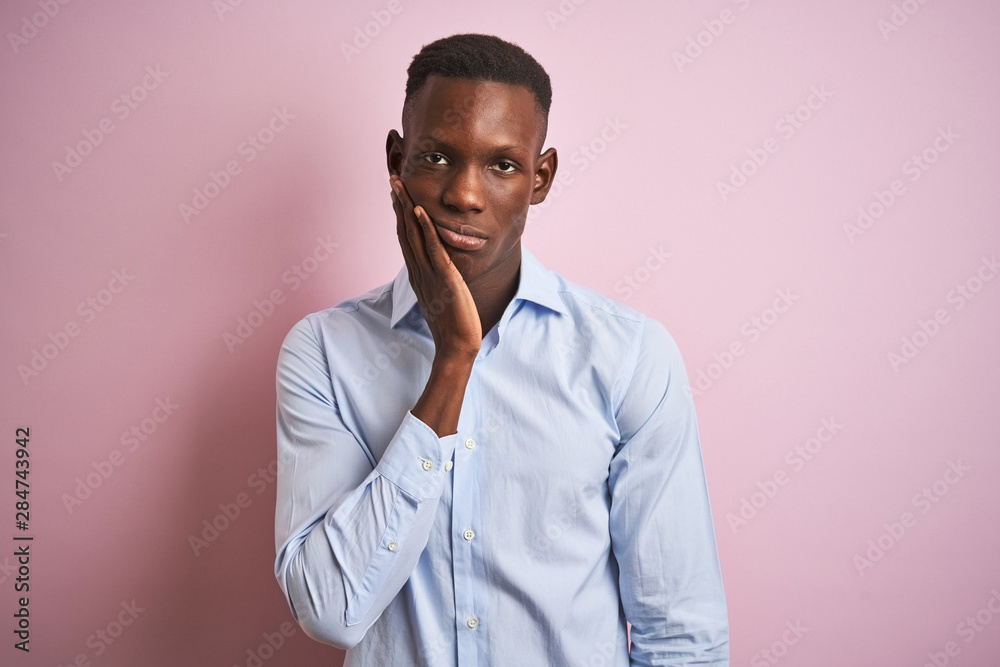 African american man wearing blue elegant shirt standing over isolated pink background thinking looking tired and bored with depression problems with crossed arms.