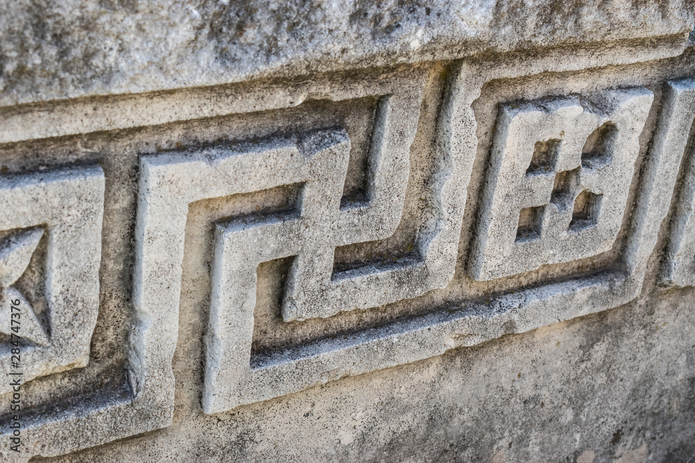 Swastika continuous ornament, carved on a Roman stone wall