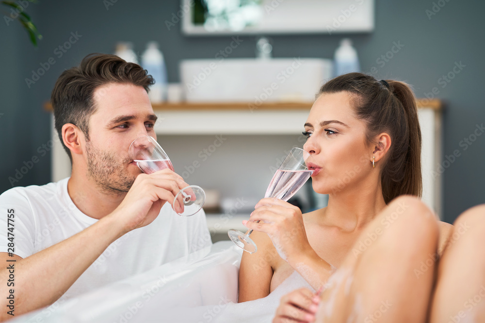 Romantic young couple enjoying and relaxing in the bathtub