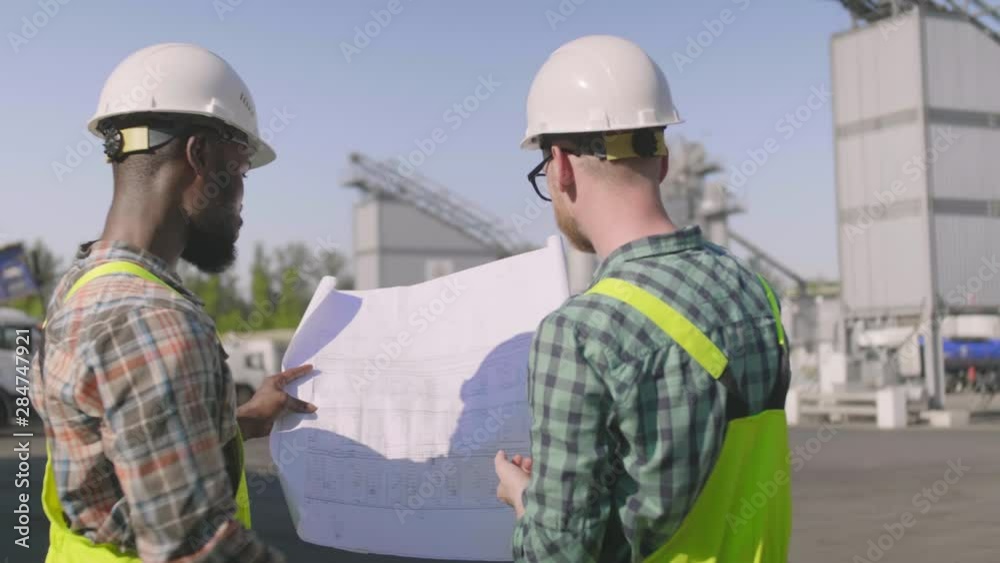 Engineer builders with blueprint plan at construction site Engineer builders with blueprint plan at construction site