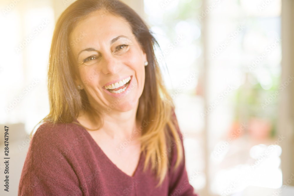 Beautiful middle age woman smiling at home Beautiful middle age woman smiling at home