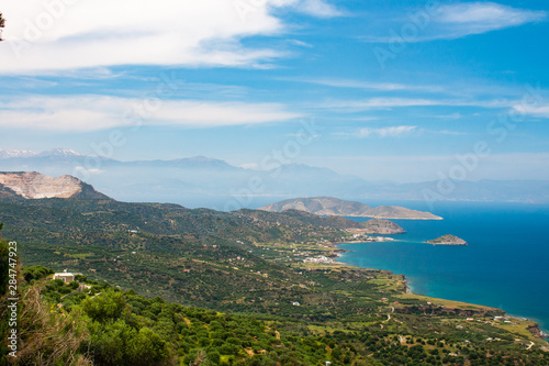 Beautiful view of the Mirabello bay. Near to Sitia and Agios Nikolaos. Landscape with turquoise sea, mountains and green nature. © Artem