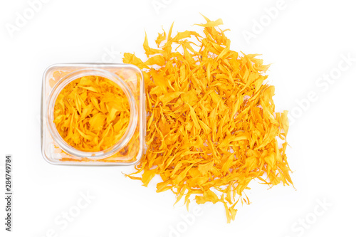 herbal calendula in the glass bottle, isolated on white background photo