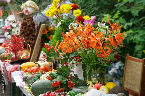 A delightful bouquet of orange tiger lilies on a farm fair counter