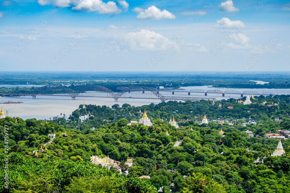 Irrawaddy Bridge or Ayeyarwady, Yadanabon Bridges with Mandalay city, temples, pagoda, Irrawaddy river. View from sagaing hill. landmark and popular for tourists attractions in Myanmar