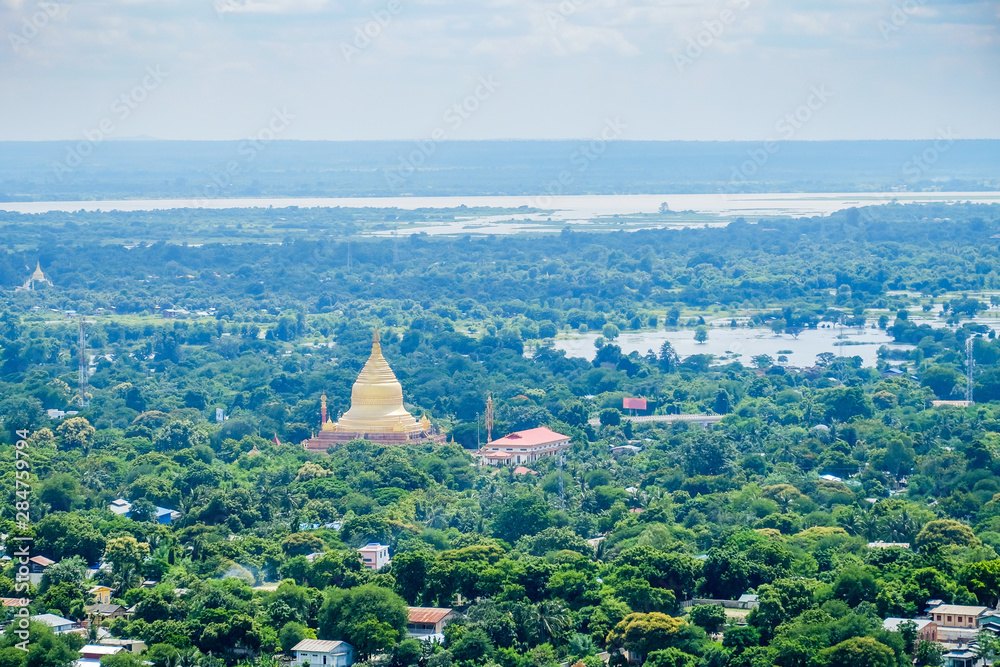 Fototapeta premium aerial view of Mandalay city with temples, gold pagoda, Irrawaddy river and bridges from sagaing hill. landmark and popular for tourists attractions in Myanmar