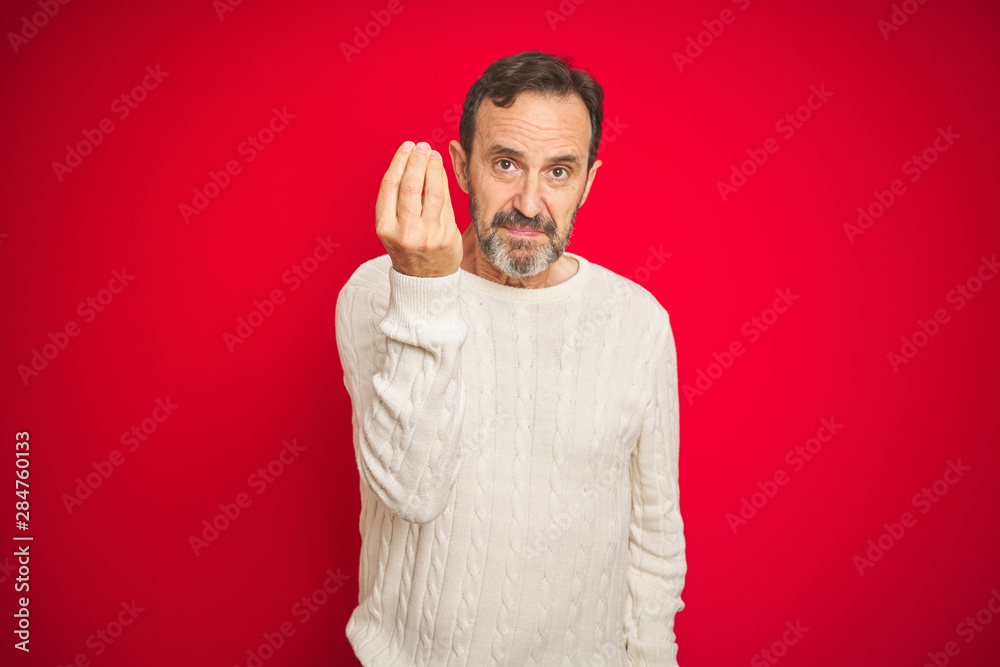 Handsome middle age senior man with grey hair over isolated red background Doing Italian gesture with hand and fingers confident expression