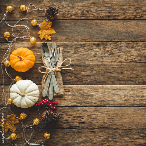 Thanksgiving background, pumpkin, leaves and decoration on wood table background with copy space. flatlay
