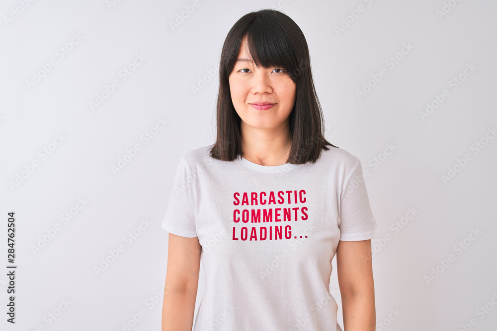 Young beautiful Chinese woman wearing fanny t-shirt over isolated white background with a confident expression on smart face thinking serious Young beautiful Chinese woman wearing fanny t-shirt over isolated white background with a confident expression on smart face thinking serious