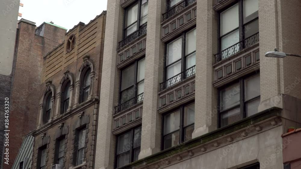 Typical day time exterior establishing shot of generic apartment or office building in urban city New York style shot in 4K DX. Typical day time exterior establishing shot of generic apartment or office building in urban city New York style shot in 4K DX.