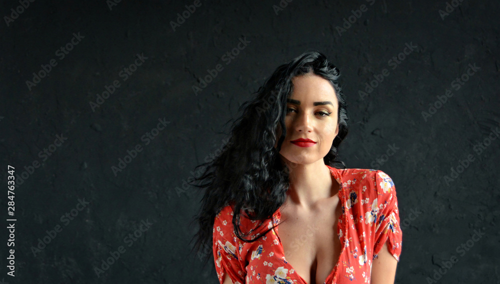 Beautiful sensual woman with gorgeous eyes, cute face and nice smile. Pretty girl with a long dark hair in a red dress with big neckline. Female portrait. Beauty. Close up. Beautiful sensual woman with gorgeous eyes, cute face and nice smile. Pretty girl with a long dark hair in a red dress with big neckline. Female portrait. Beauty. Close up.
