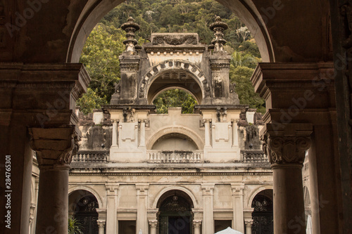 Rio de Janeiro, Brazil - August 17, 2019: Weathered colonial architecture of the public Parque Lage, built in the 1920s, reflects the jungle forest of the surrounding Tijuca National Park.