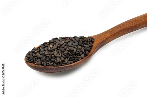 Close up wooden bamboo spoon with black sesame seed isolated on white background.