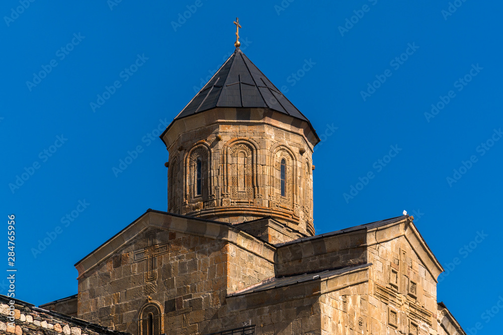 Trinity Church in Gergeti on a background of blue sky