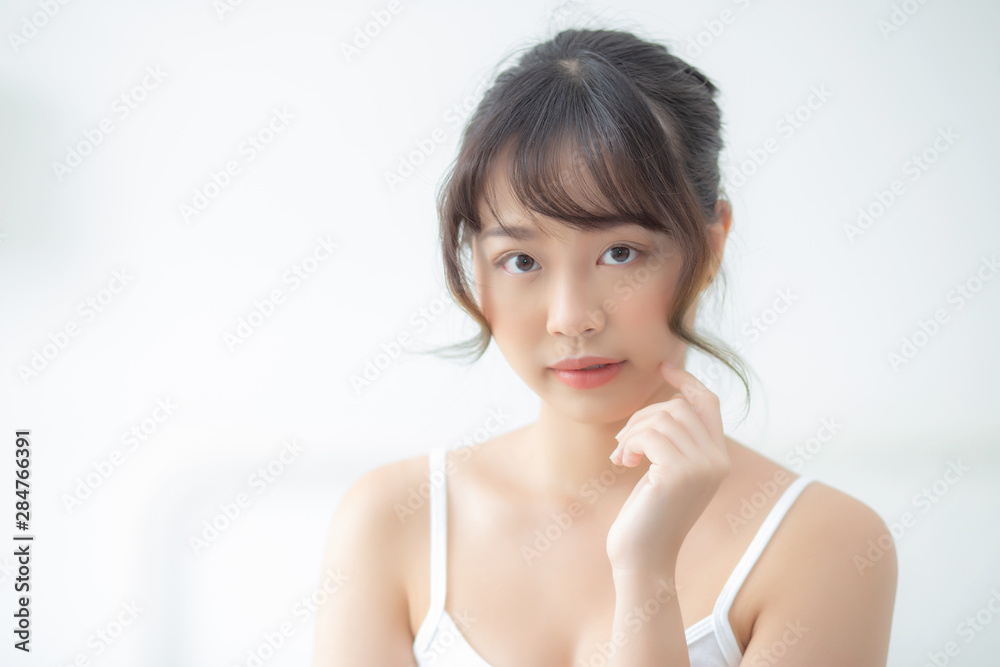 Portrait of beautiful young asian woman smile while wake up healthy and wellness with sunrise at morning in the bedroom, asia girl skin care with happy with fresh, lifestyle and relax concept. Portrait of beautiful young asian woman smile while wake up healthy and wellness with sunrise at morning in the bedroom, asia girl skin care with happy with fresh, lifestyle and relax concept.