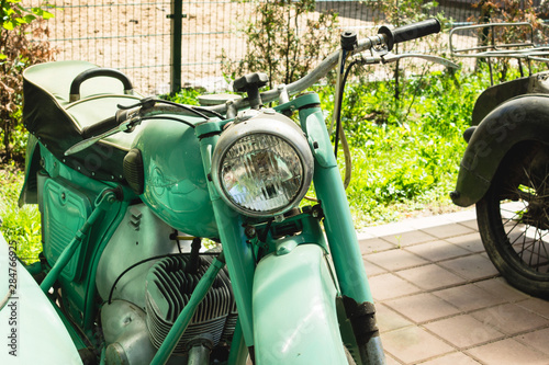 Izh green brand motorcycle at motorcycle exhibition.transport with a pram. vintage motorcycle photo