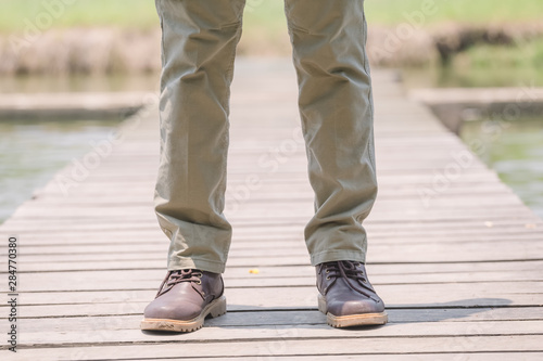 Model wearing sofe green color cargo pants or cargo trousers © PRASERT