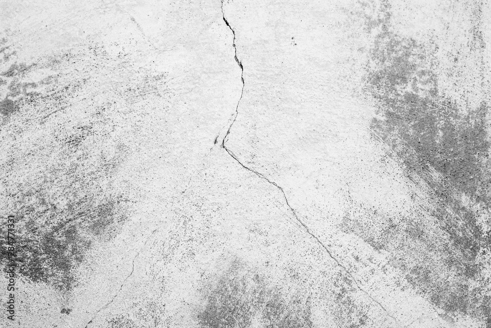 Fototapeta premium Texture of a concrete wall with cracks and scratches which can be used as a background