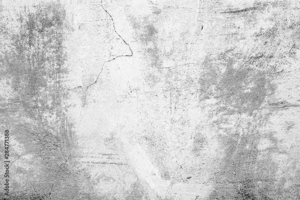Fototapeta premium Texture of a concrete wall with cracks and scratches which can be used as a background