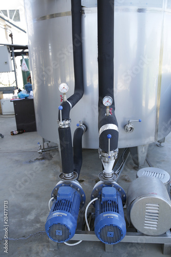 shiny tank or barrel at a beer and wine factory. Industry Brewing and winemaking. Equipment for the winery and brewing industrial interior of a factory