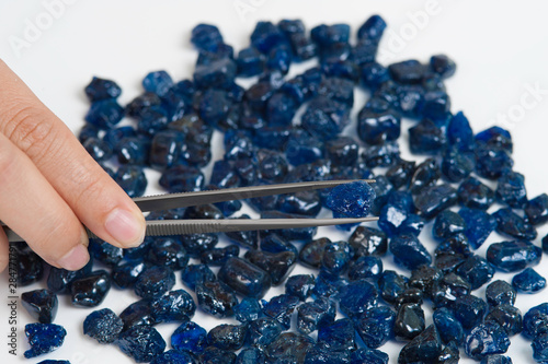 Collection of lovely blue rough and uncut sapphire gemstones. photo