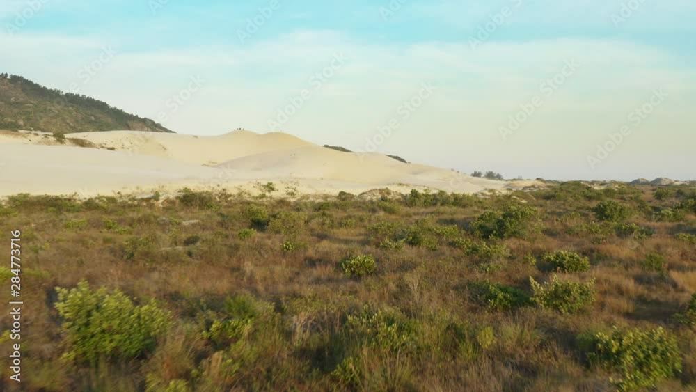 Aerial action view approaching sand dunes at Praia Da Joaquina, Florianopolis city, Santa Catarina, Brazil Aerial action view approaching sand dunes at Praia Da Joaquina, Florianopolis city, Santa Catarina, Brazil