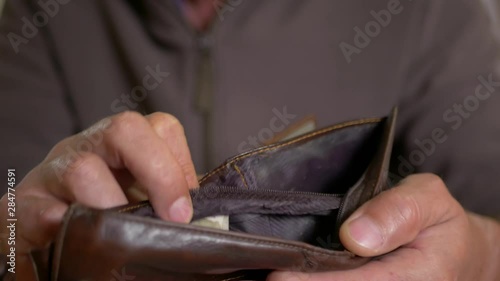 Wallpaper Mural Caucasian worker with a missing finger opening  hes empty wallet, conceptual footage of underpaid labour. Torontodigital.ca