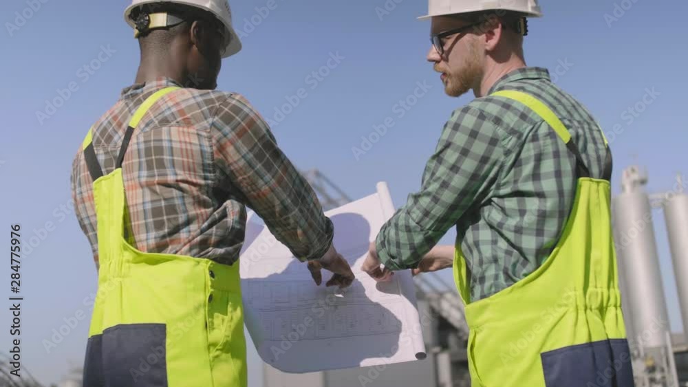 Engineers working with blueprint