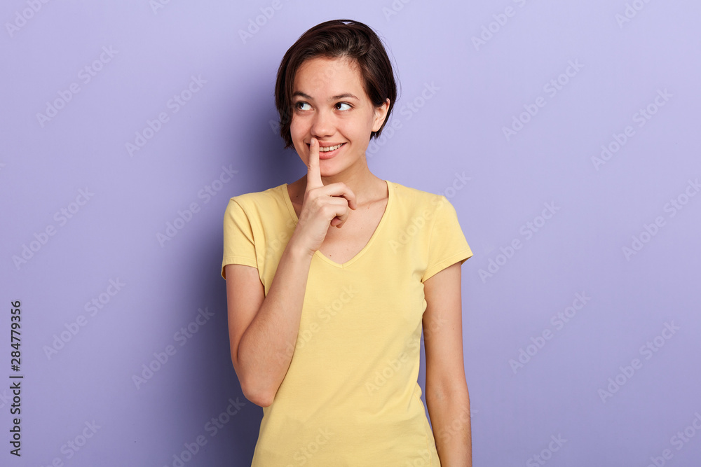 Thoughtful attractive smiling young woman looking up, close up portrait, isolated violet background, studio shot. copy space. place for text. Thoughtful attractive smiling young woman looking up, close up portrait, isolated violet background, studio shot. copy space. place for text.