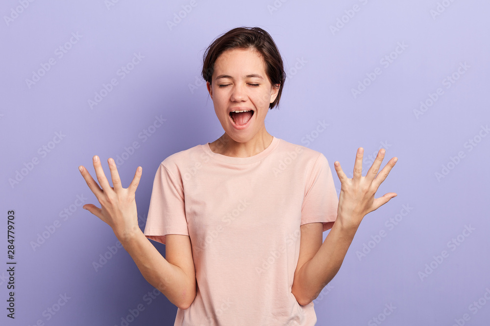 good-looking, charming , crazy woman with closed eyes, open mouth screaming with raised arms. close up portrait, studio shot.facial expression, feeling and emotion good-looking, charming , crazy woman with closed eyes, open mouth screaming with raised arms. close up portrait, studio shot.facial expression, feeling and emotion