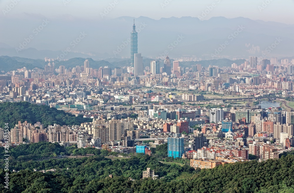 Aerial panoramic scene of overpopulated Taipei City in a hazy morning with a view of landmark tower in XinYi District, and Keelung River through the downtown area  Air pollution level of PM2.5 class