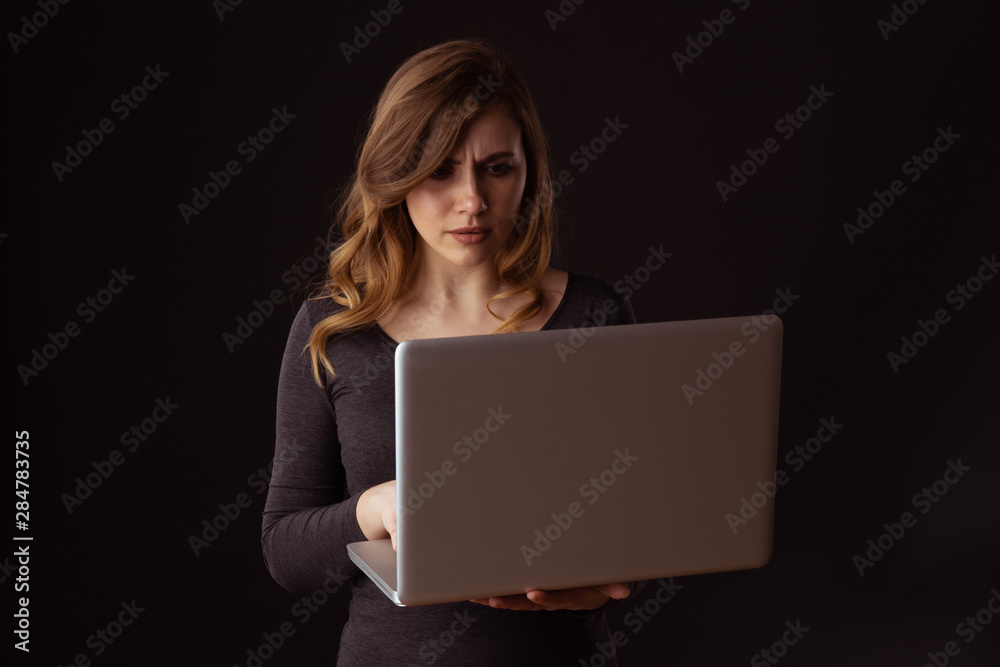 Worried woman with laptop isolated. Computer problem concept. Worried woman with laptop isolated. Computer problem concept.