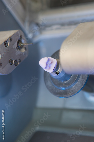 finished dental implant in the CEREC dental milling machine in the doctor's office