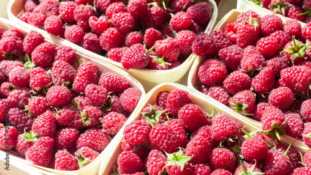 A lot of fresh raspberries in containers. Useful food A lot of fresh raspberries in containers. Useful food