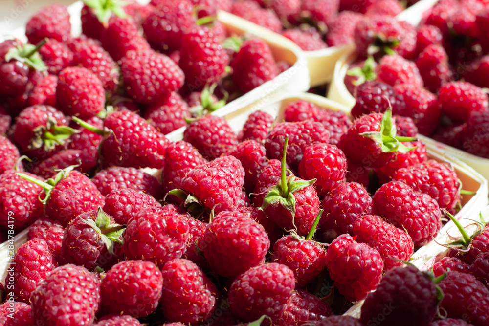 A lot of fresh raspberries in containers. Useful food A lot of fresh raspberries in containers. Useful food