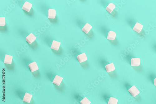 Geometry Pattern made of white sugar cubes on light blue background. Abstract, minimal style.