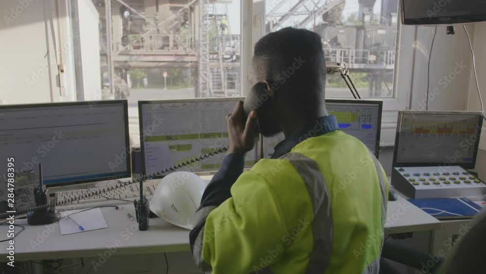 Engineer talking on phone in control room
