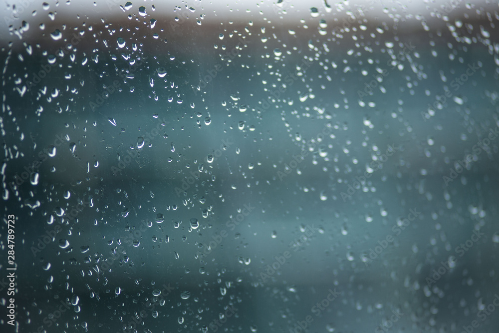 Raindrops on the glass. Drops on the window, blue background Raindrops on the glass. Drops on the window, blue background