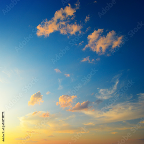 Scenic sunset with sun rays against bright blue sky © Serghei V