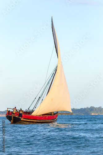 traditional dhow sailing vessel used to transport people goods and commodities heading to sea and the open ocean
