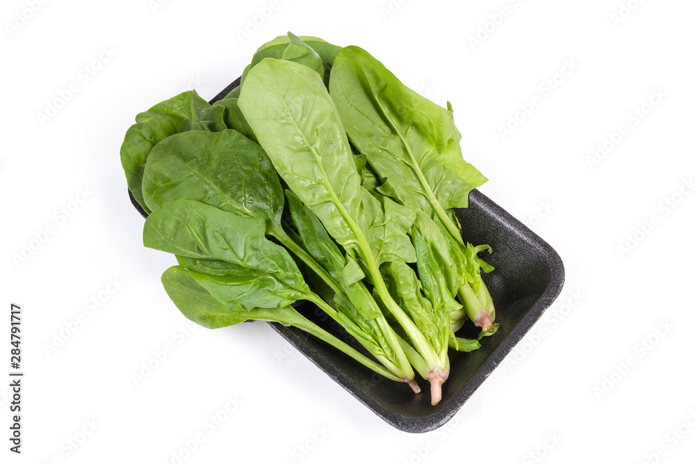 Leaves of fresh spinach on the foam food container Leaves of fresh spinach on the foam food container