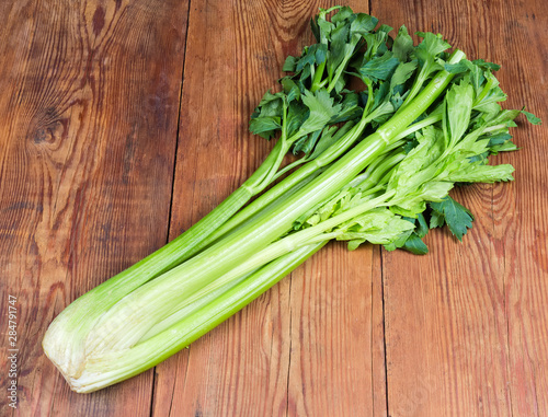 Fresh bunch of celery stalks on the rustic table