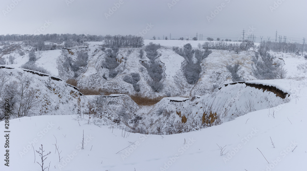 Winter panoramic landscape with ravine covered with fresh snow in suburbs of Dnipro city, Ukraine Winter panoramic landscape with ravine covered with fresh snow in suburbs of Dnipro city, Ukraine